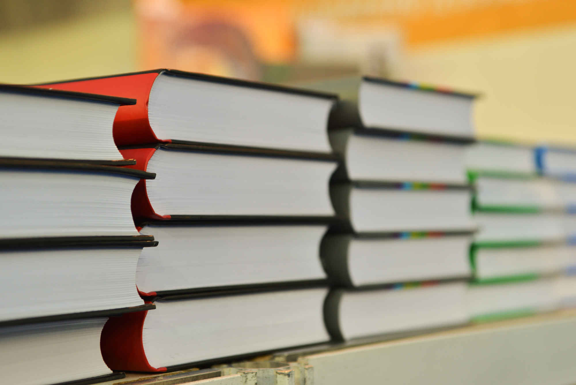 Stack of books on wooden deck table