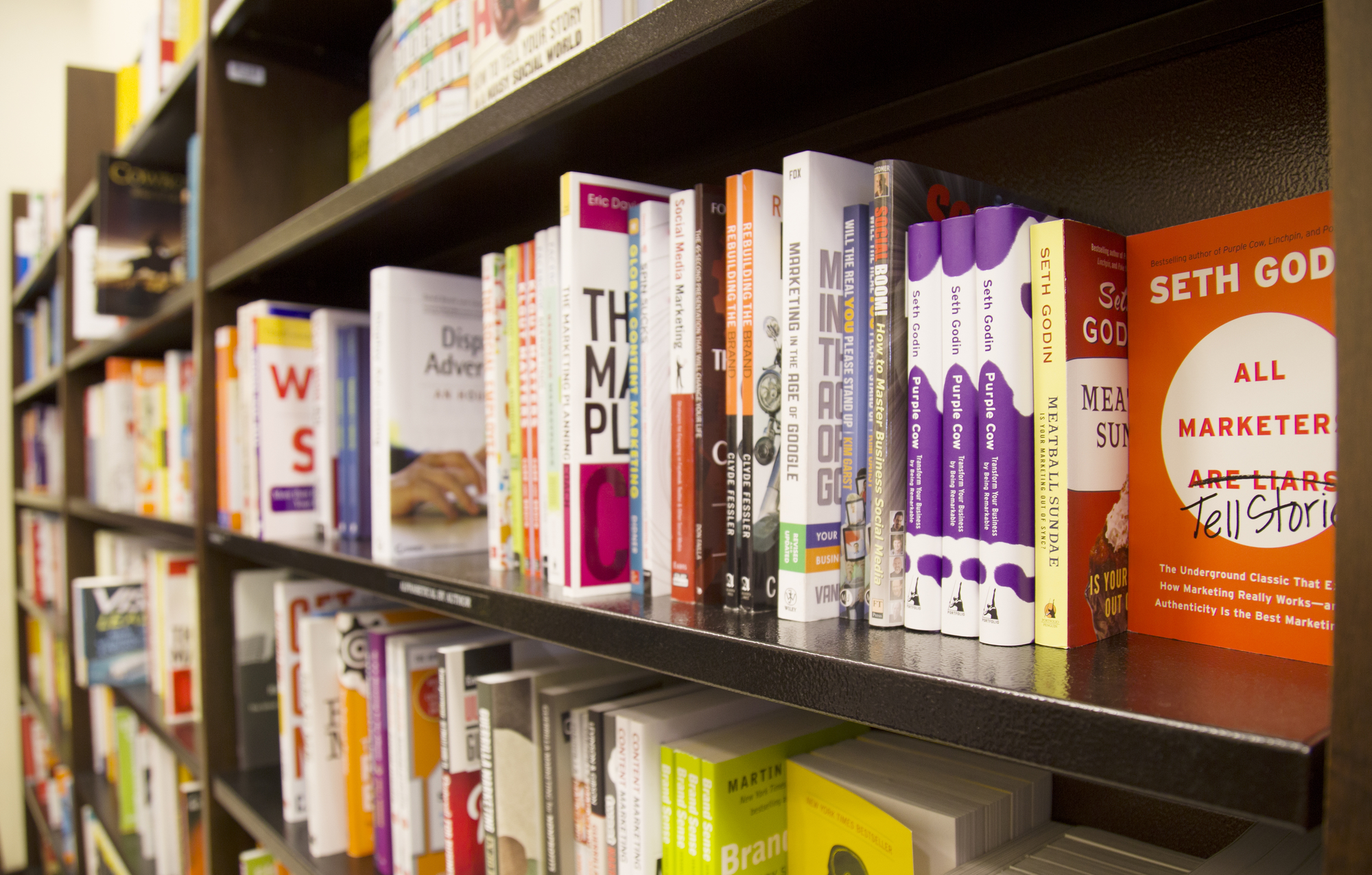 Oblique view of books placed on bookshelves
